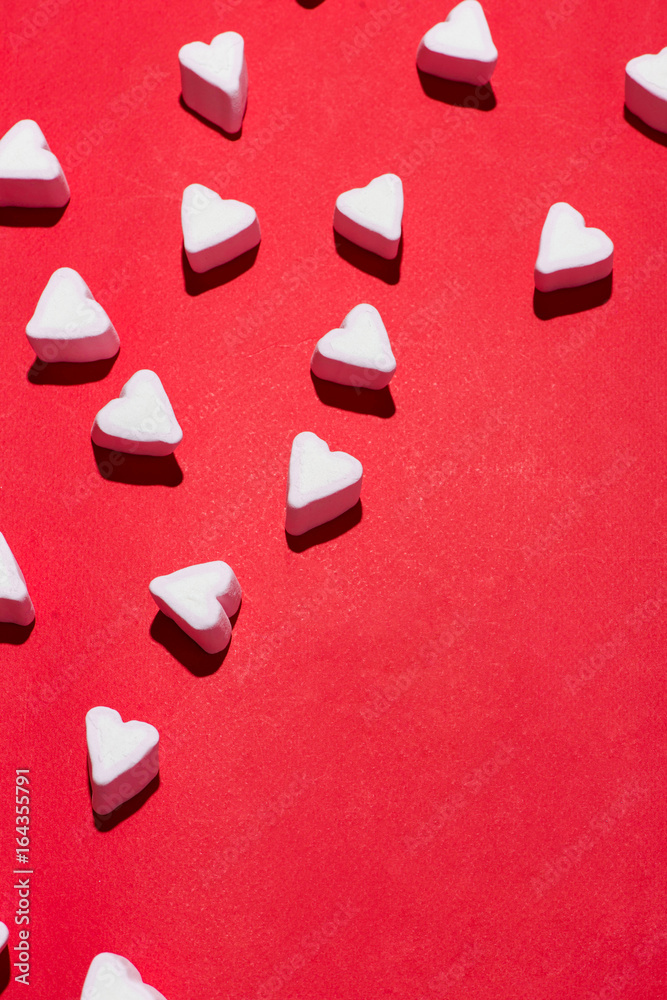 Valentines Day candy hearts marshmallows over red background