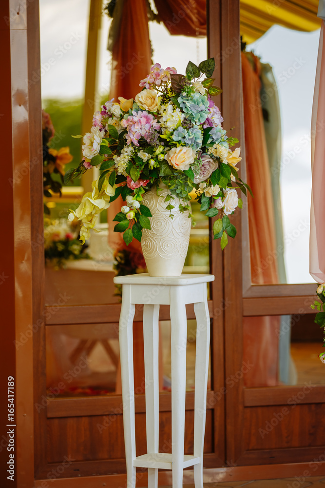 Beautiful tender bouquet on elegant white stand (table)