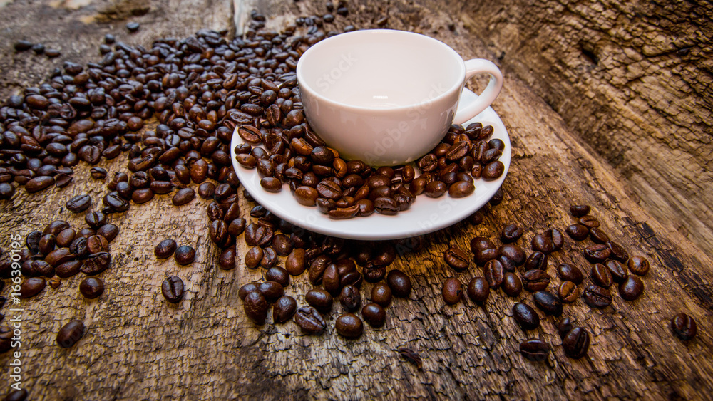 Coffee. Coffee beans. Coffee cup with coffee beans on a wooden background