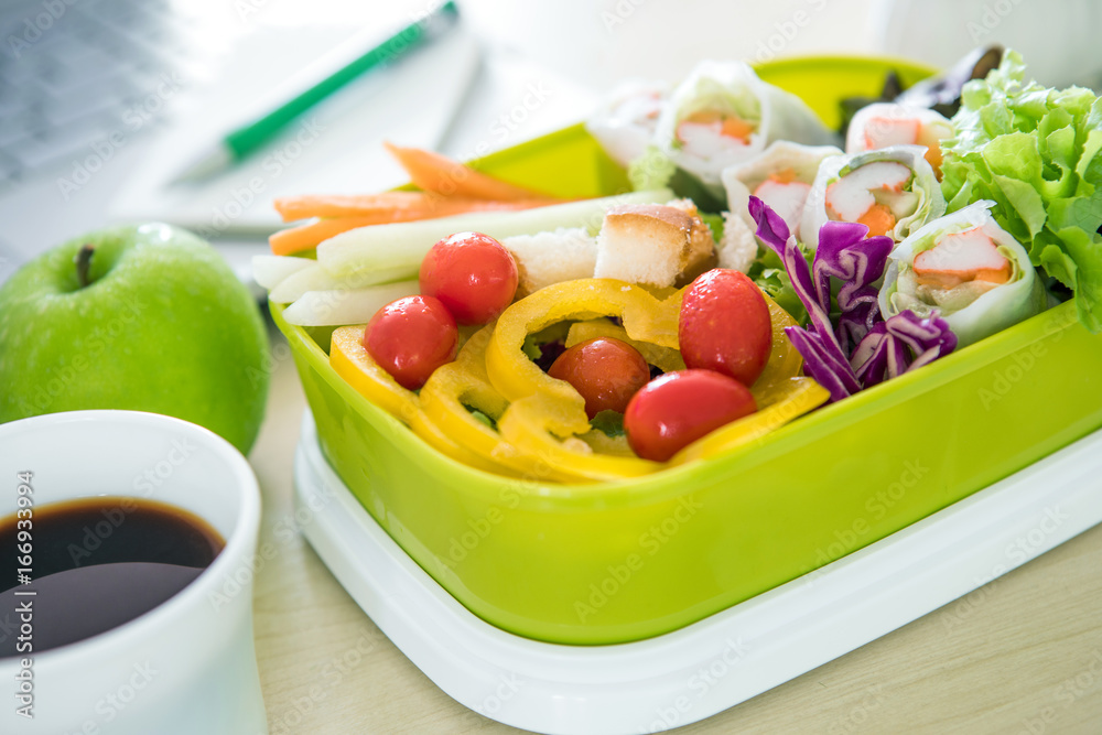 Close up green Lunch box on the work place of working desk ,Healthy eating clean food habits for die