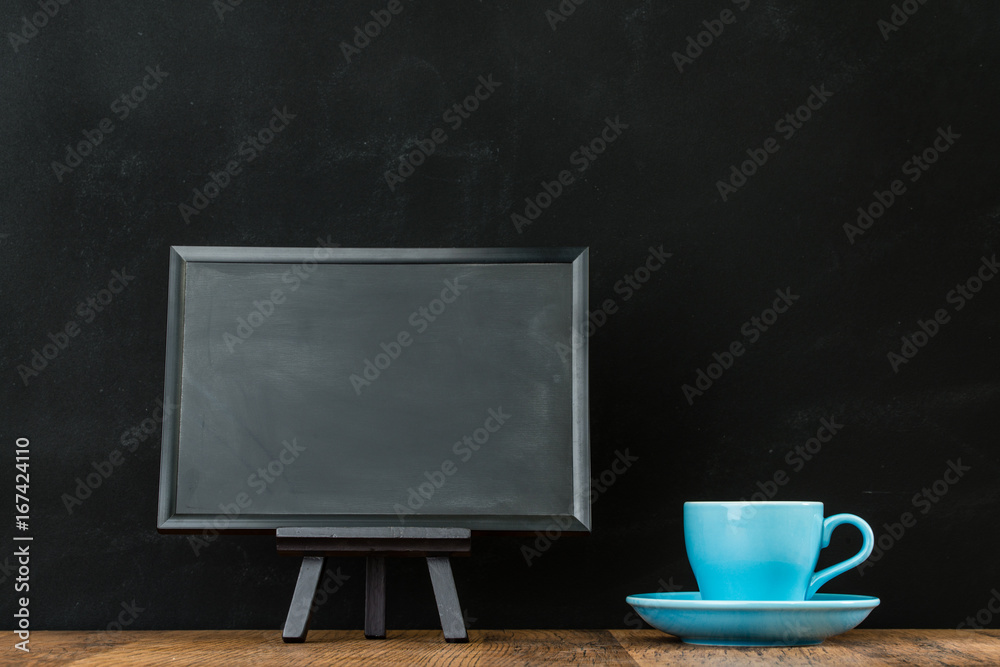 粉笔黑板旁边的蓝色咖啡杯