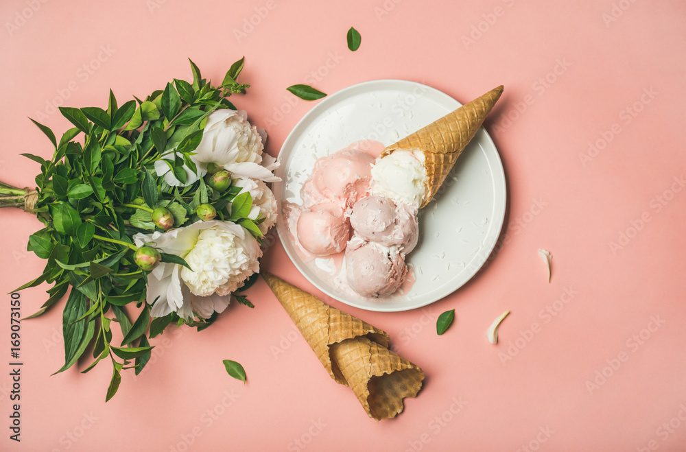 淡粉色草莓和椰子冰淇淋勺，白色盘子上的甜甜筒和白色