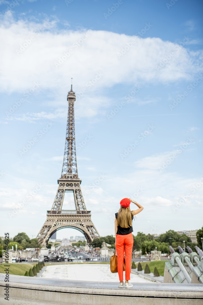 Woman in red enjoying great view on the Eiffel tower in Paris