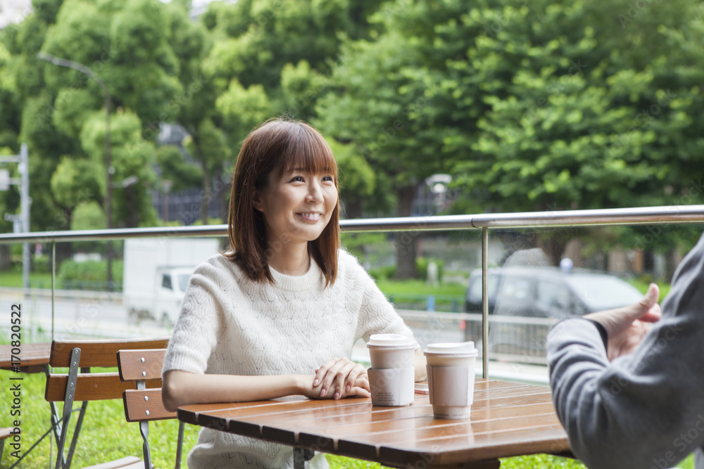 A young couple who talks happily on the cafe terrace