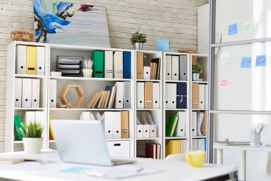 Background image designer office space with bookcase and desk
