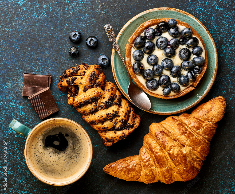 Breakfast with croissant, tart and coffee. Bakery products.