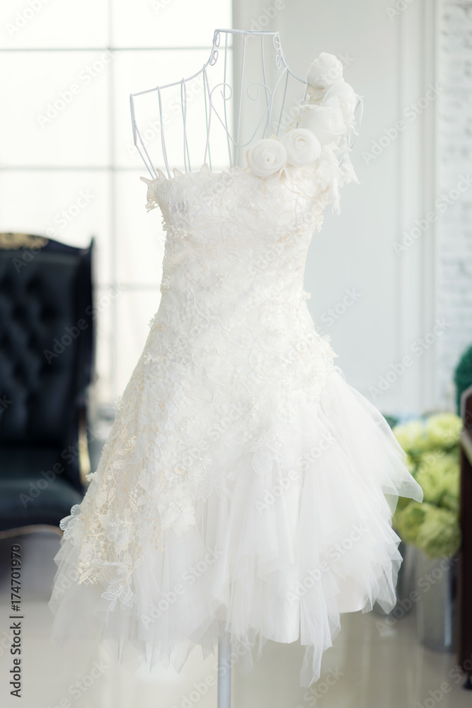 Beautiful wedding dresses on a mannequin in wedding studio.
