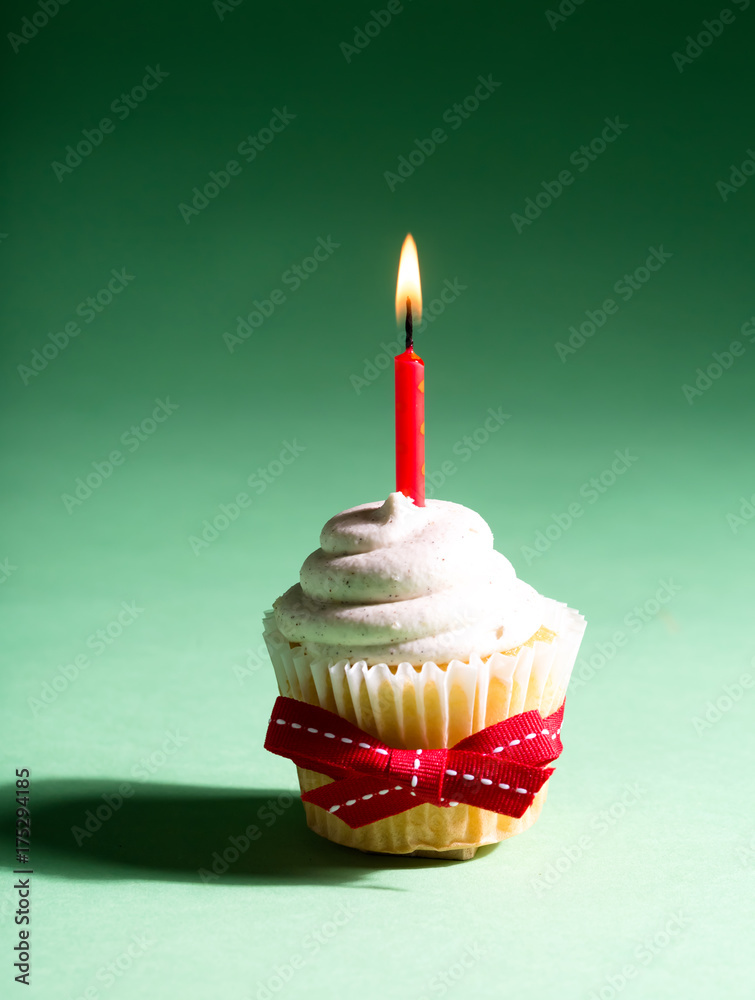 Cupcake with candle celebration theme on a dark green background