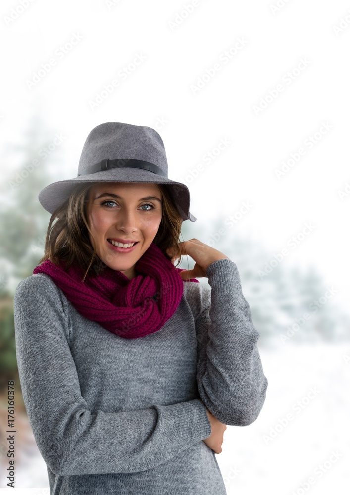 Woman wearing hat and scarf in snow forest