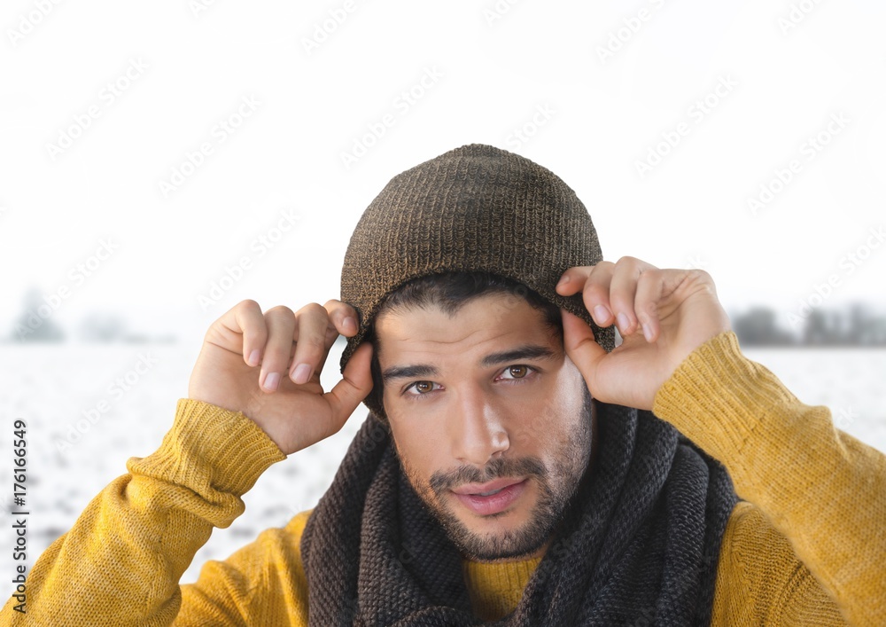 Man wearing hat and scarf in snow landscape