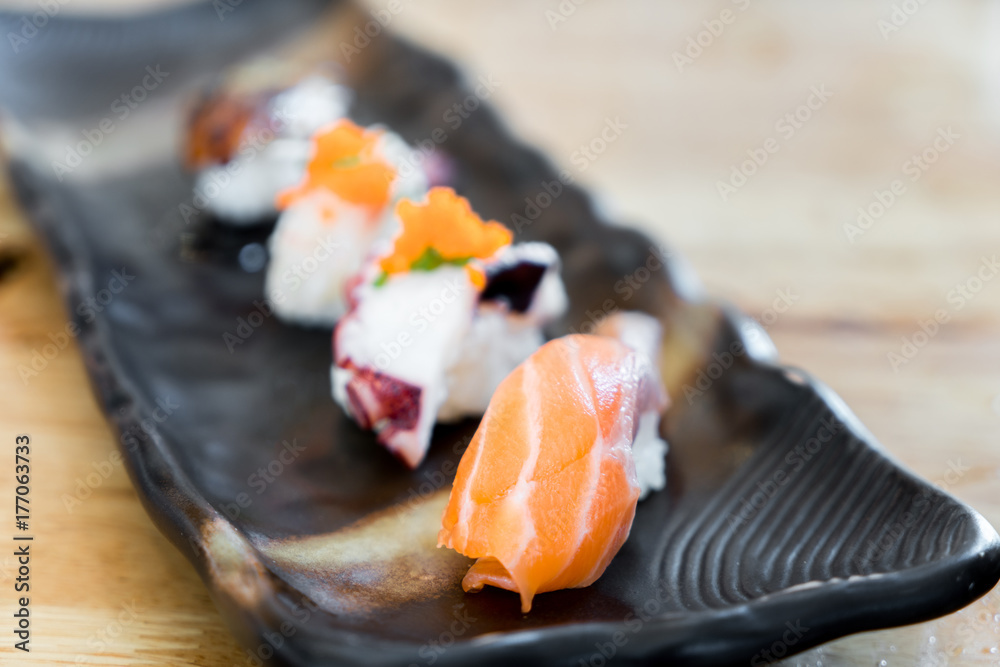 Japan raw salmon sushi and fresh mix sushi set in black plate - Japanese food set style at Japanese 
