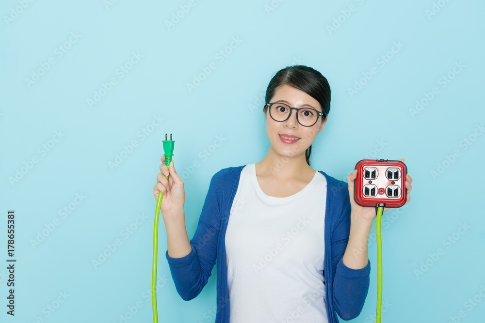 attractive young lady showing plug with socket