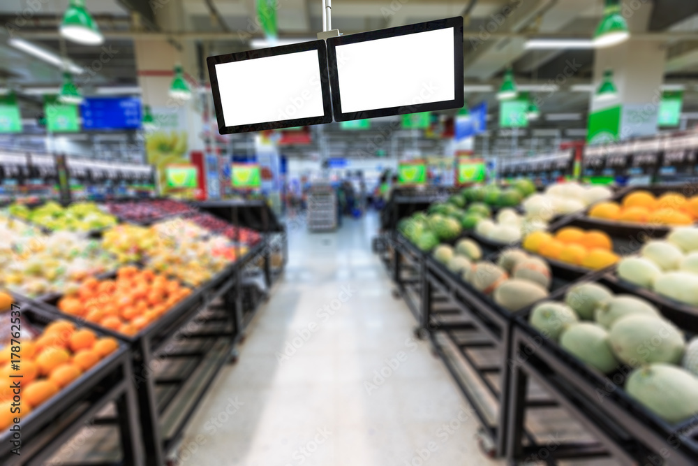 Blank supermarket TV screen and blurred supermarket fruits background