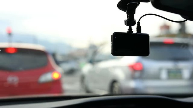video camera recorder in car driving traffic jam on urban road
