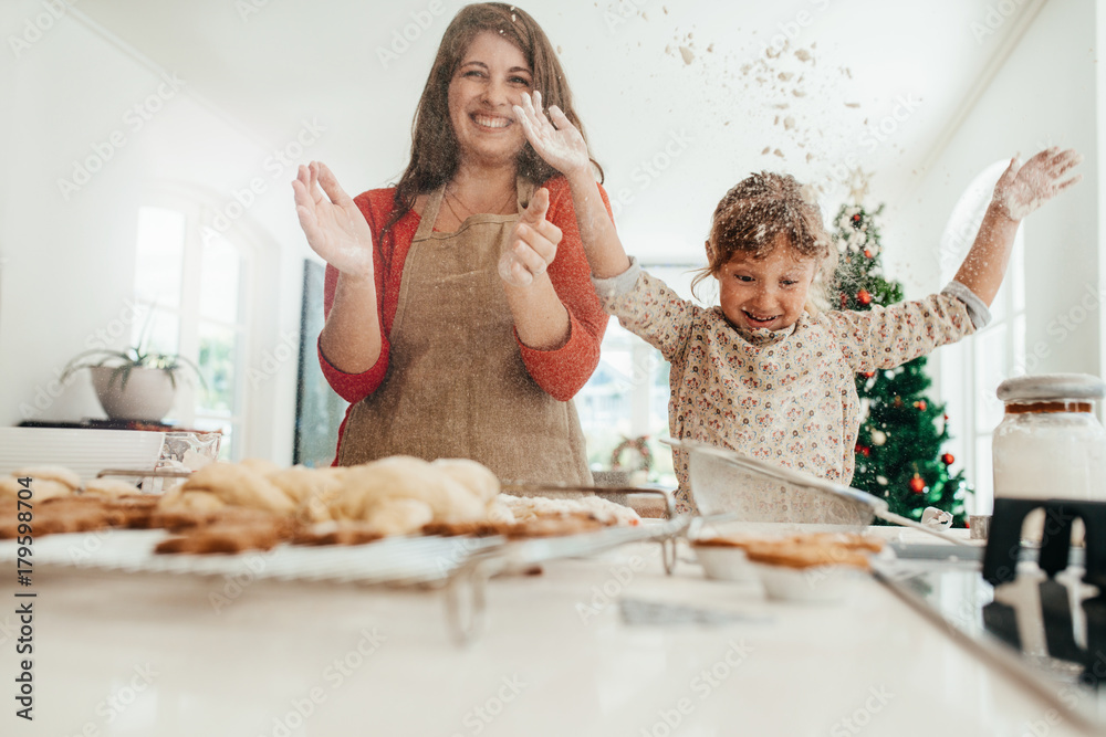 Mother and daughter having fun while making Christmas cookies.