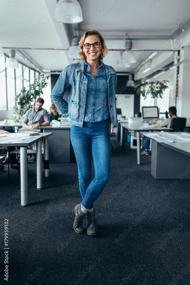 Young female manager standing in office