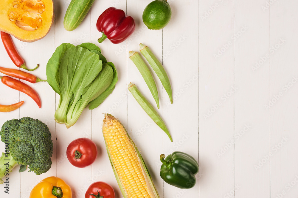 Assortment of the fresh vegetables on wooden background