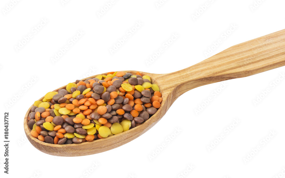 Lentils mix in wooden spoon isolated on white background. Mixed red, yellow and brown lentils.
