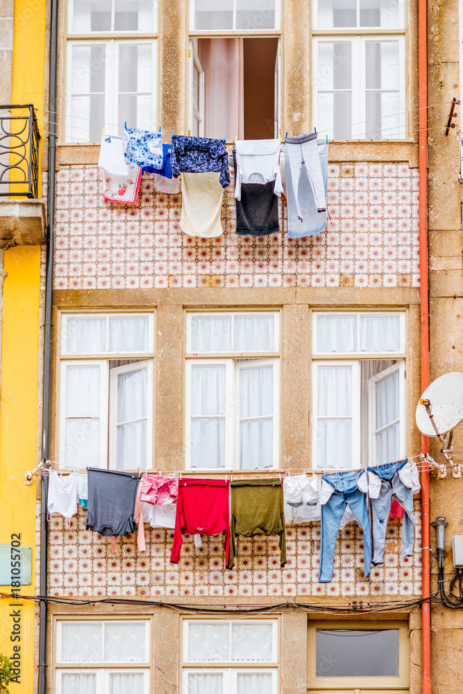Colorful clothes drying on the windows of the old buildings in Porto city, Portugal