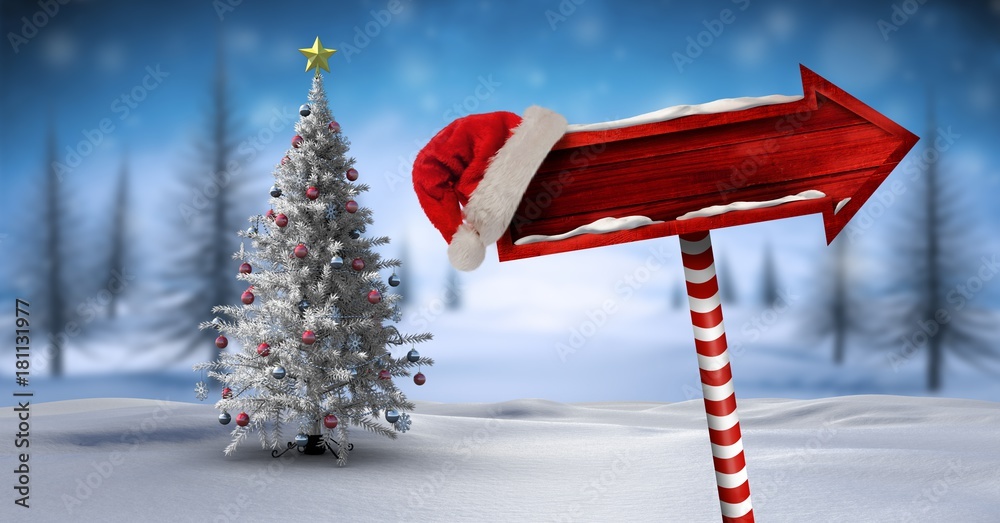 圣诞冬季景观中的木制路标和圣诞老人帽