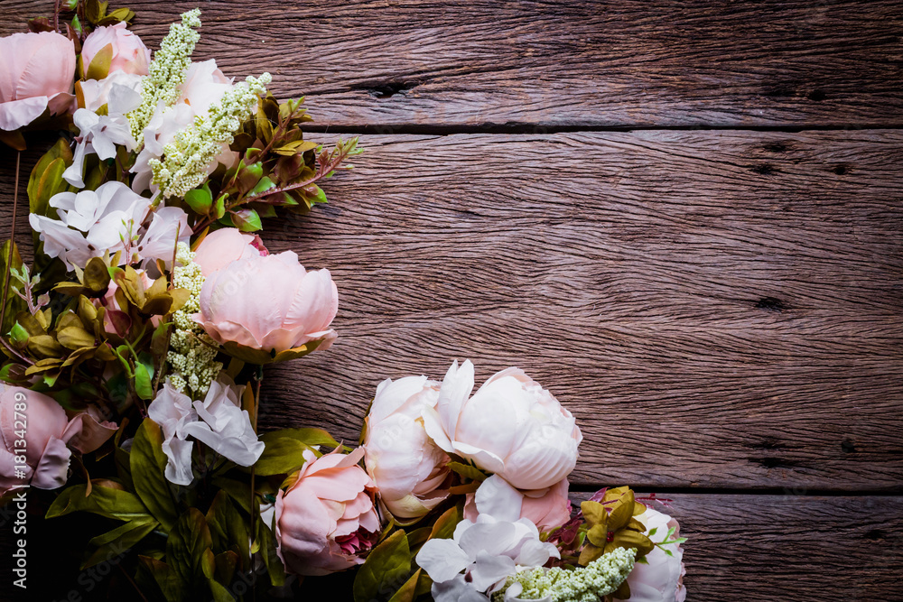Frame from flowers on vintage wooden background. Selective focus. Place for text.