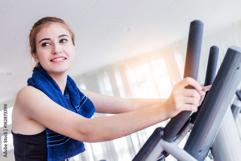 beautiful and smart healthy caucasian young woman smile while workout at gym fitness center with blu