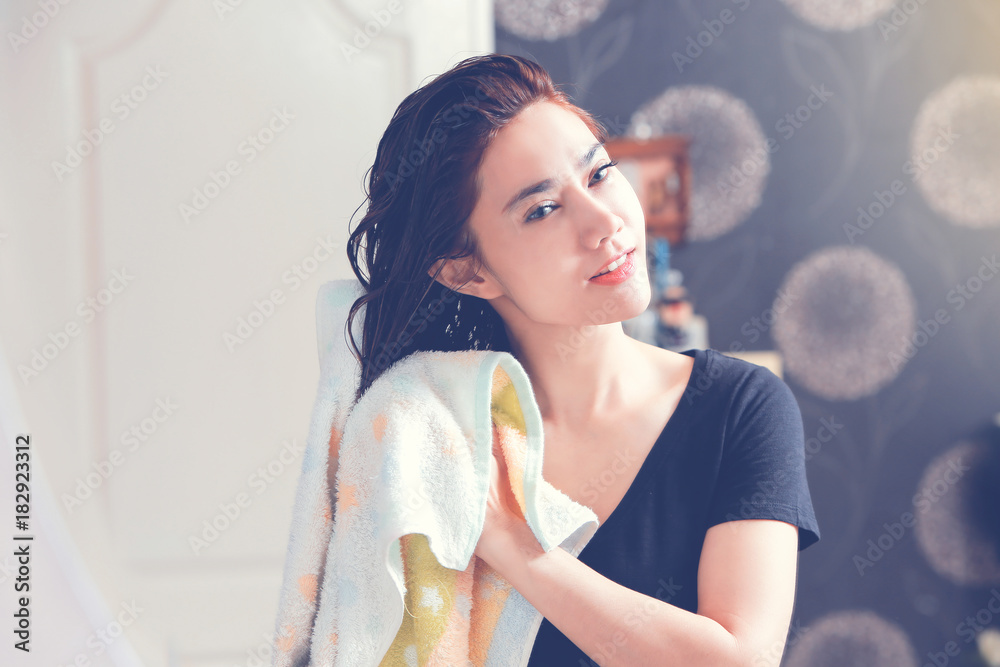 Young woman with wet hairs in bathroom