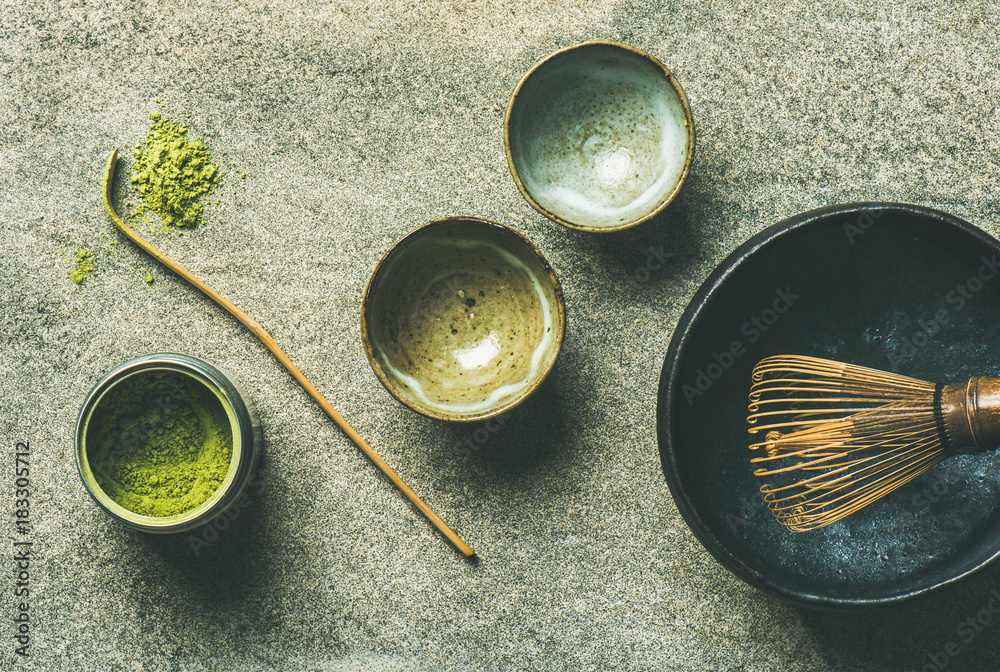 Flat-lay of Japanese tools for brewing matcha green tea. Matcha powder in tin can, Chashaku spoon, C