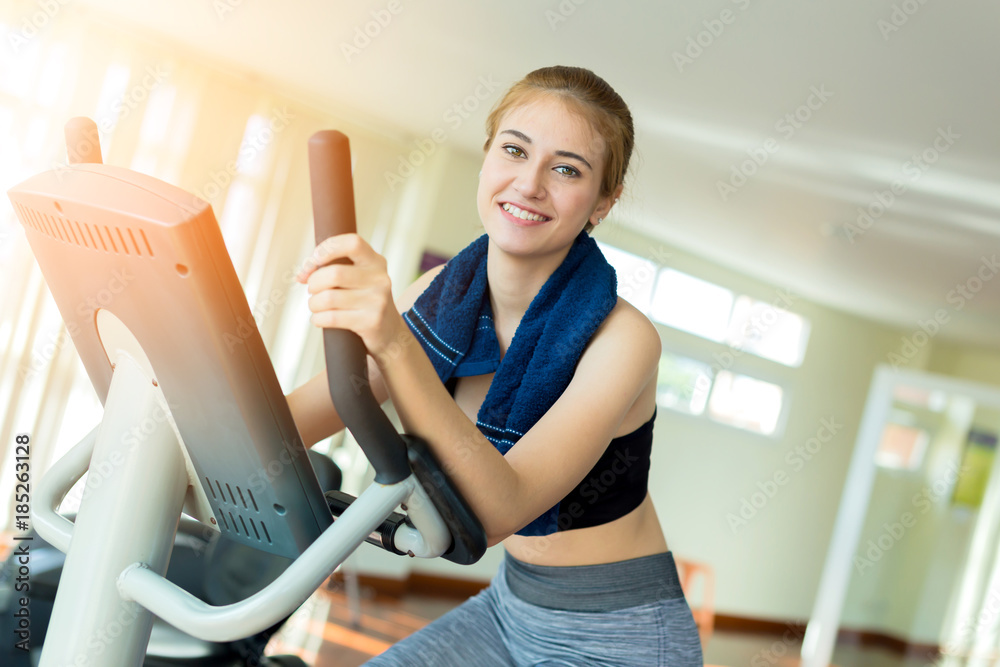 beautiful and smart healthy caucasian young woman smile while workout at gym fitness center with blu