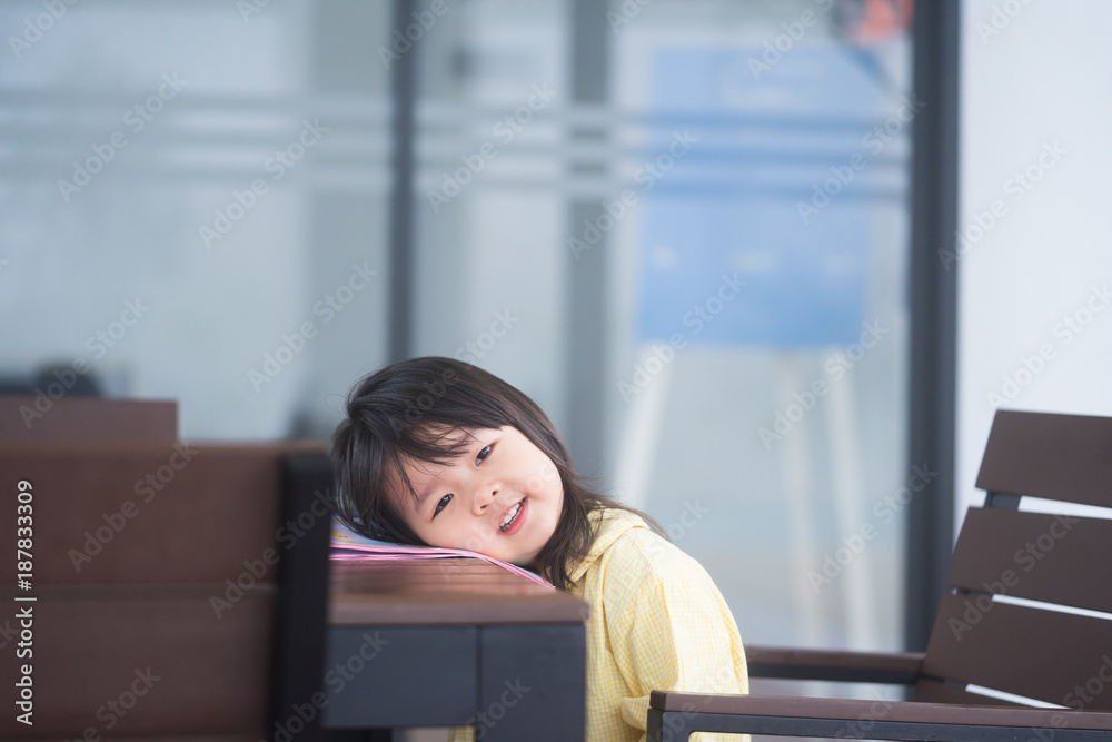 一个小学年龄的孩子做家庭作业。这个小女孩在家里的桌子上做作业。