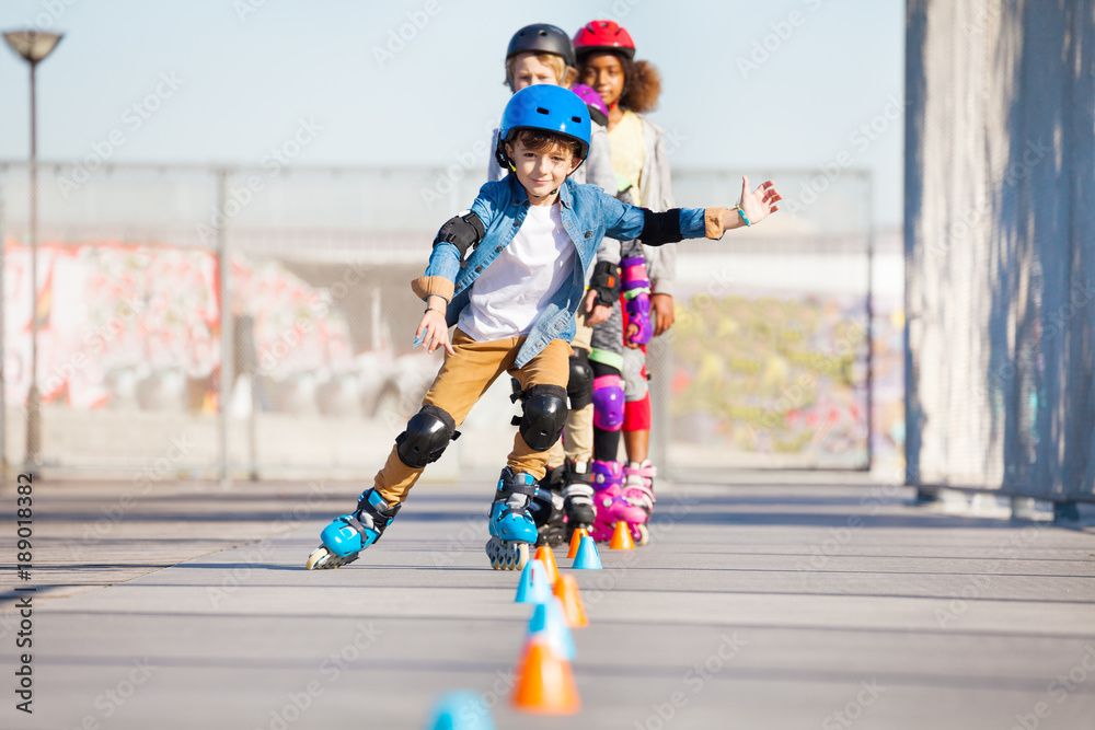Happy inline skater practicing slalom skating