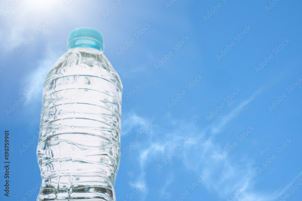 Drinking water concept.Drinking water bottle on blue sky background in summer.