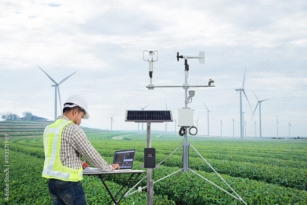 Engineer using tablet computer collect data with meteorological instrument to measure the wind speed