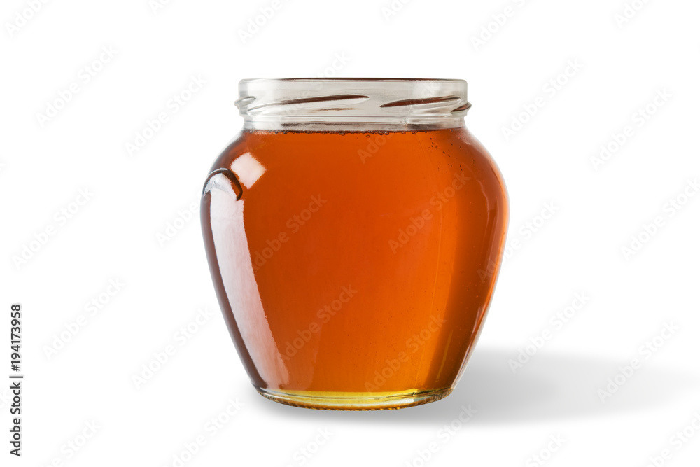 白色背景下分离的罐子里的蜂蜜。