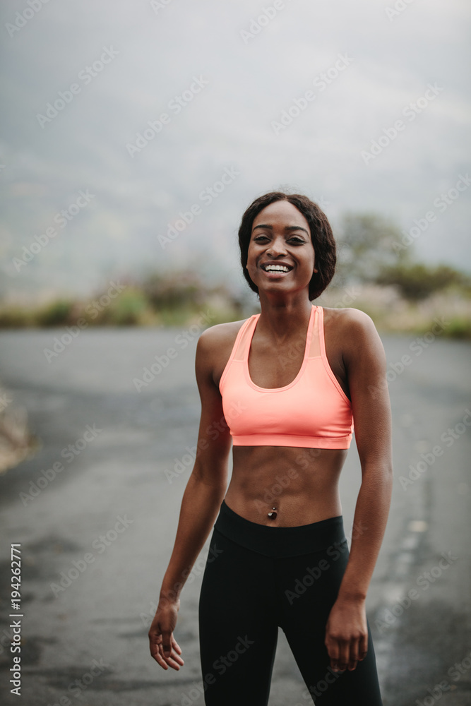 Young woman athlete on road