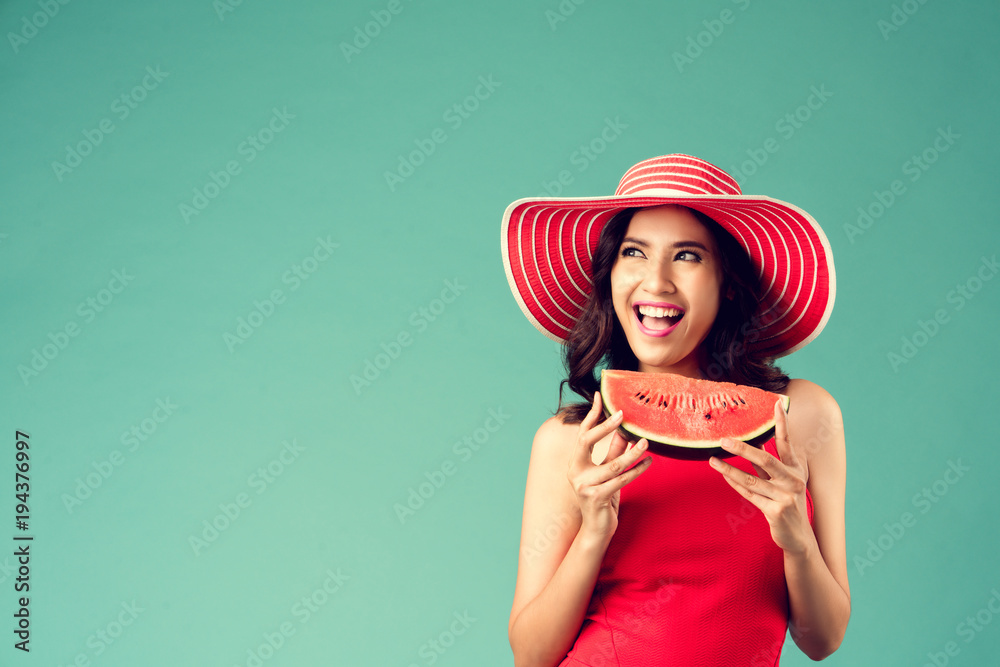 Women wear dresses. She is eating watermelon. In the summer She feels refreshed