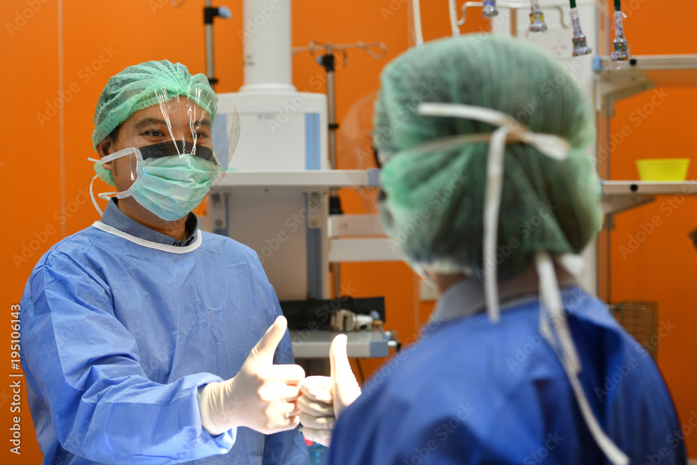 Team surgeon congratulating a successful operation in an operating room