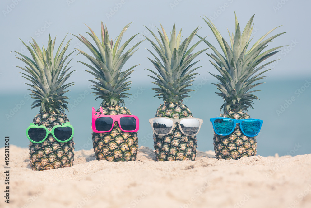 Attractive pineapples on the beach Wearing stylish mirrored sunglasses, Tropical summer vacation con