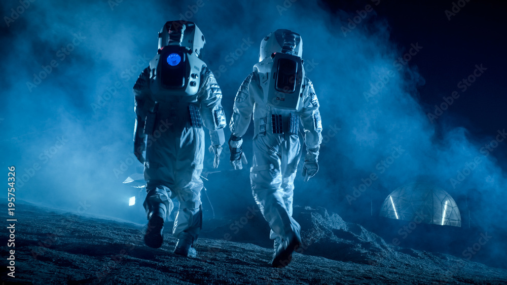 Shot of Two Astronauts in Space Suits on Alien Planet Walking Toward Rover and Geodesic Dome. High-T