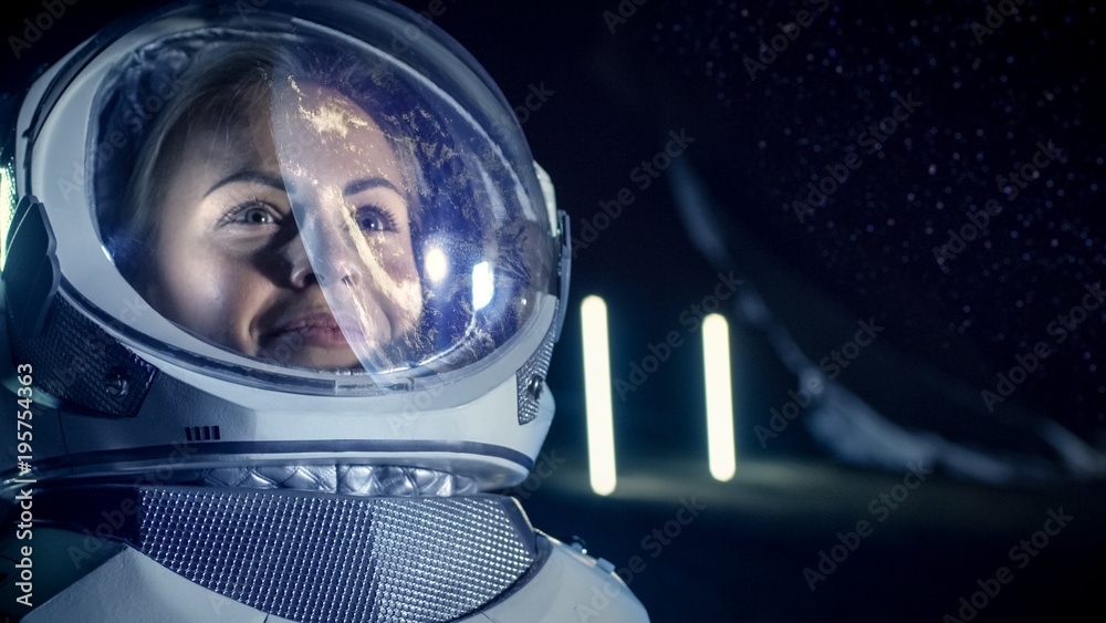 Portrait of the Beautiful Female Astronaut on the Alien Planet. Earth Reflection on her Helmet. In t