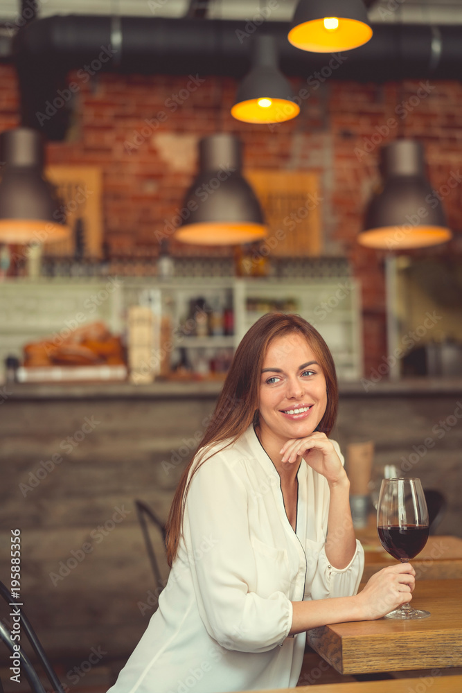 Smiling girl with a glass indoors