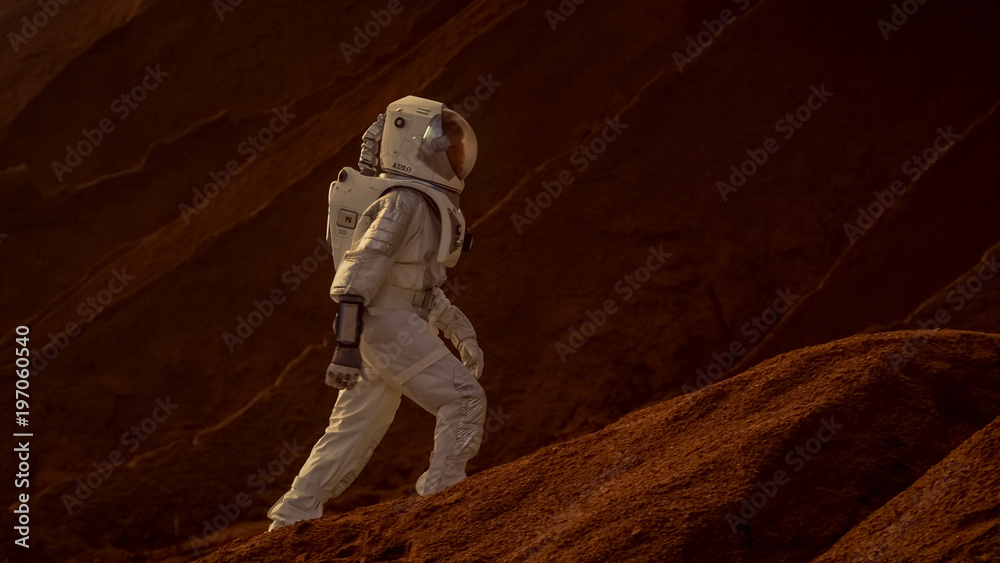 Astronaut Goes Up the Mountain to Explore Red Planet/ Mars. In the Background His Base and AI Powere