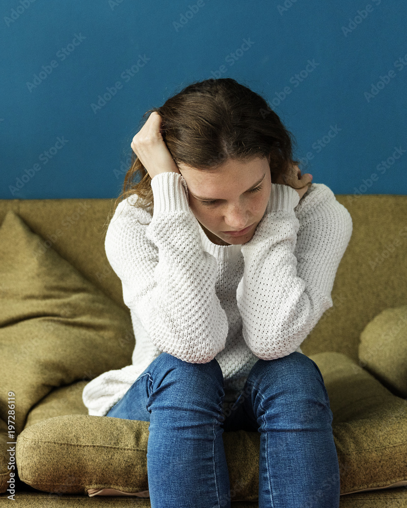 Stressed teenager sitting on a sofa