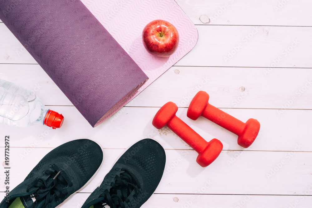 Yoga mat, sport shoes, dumbbells and bottle of water on blue background. Concept healthy lifestyle, 