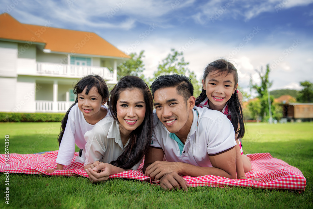 Asian family picnic togater in resort garden