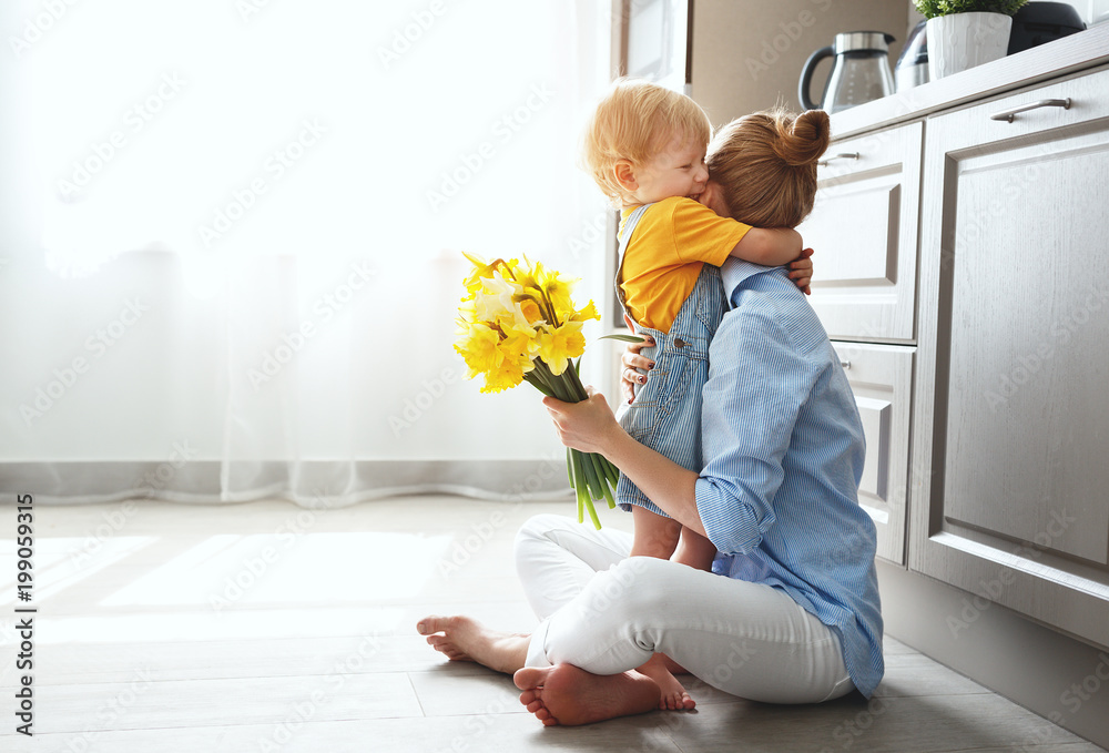 happy mothers day! baby son gives flowersfor  mother on holiday