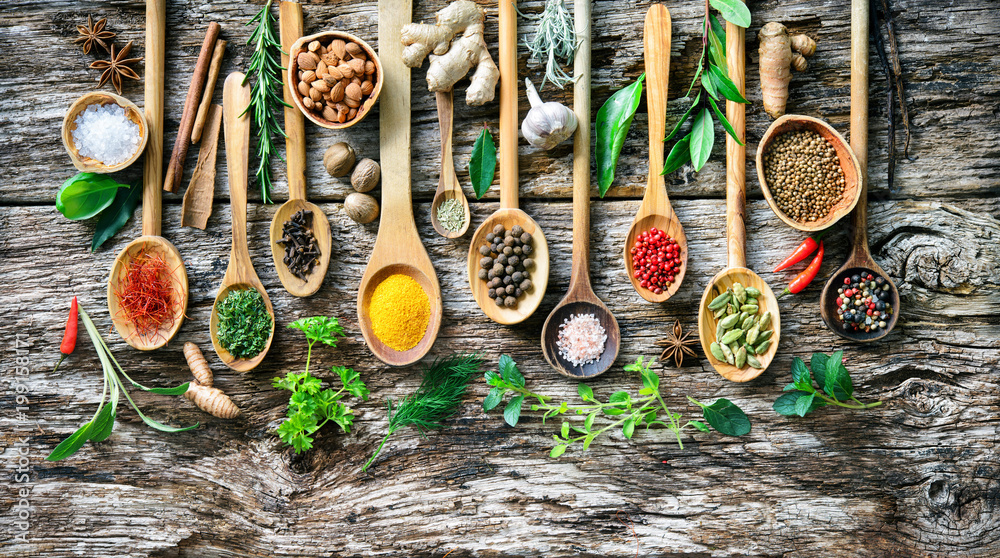 Various herbs and spices for cooking on old wooden board