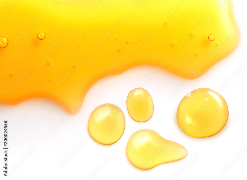 Macro close up of  honey drops isolated on white background