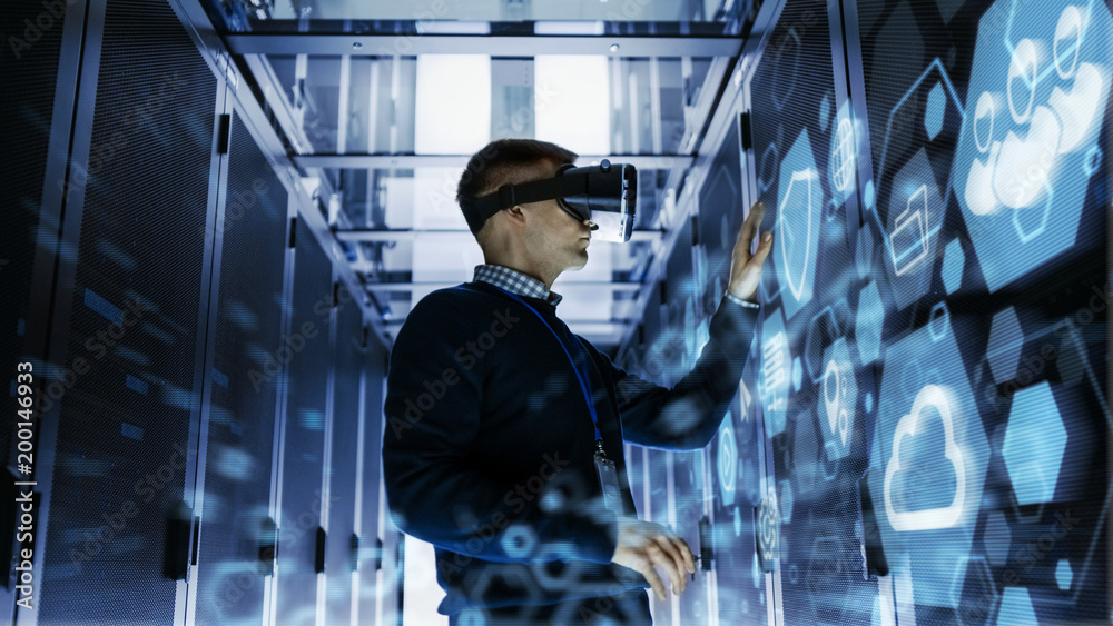 IT Engineer Wearing Virtual Reality Headset Works with Augmented Reality Software in Data Center. He