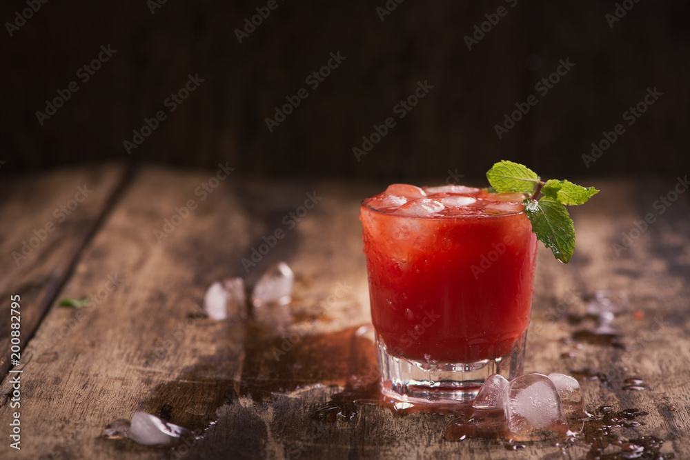 木制桌子上玻璃杯里的清爽夏日西瓜汁。